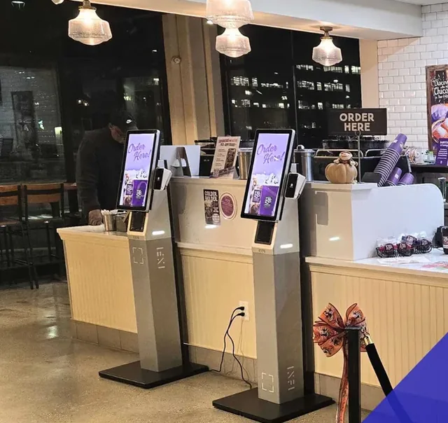 Two INFI self-ordering kiosks on the counter at a PJ&rsquo;s Coffee store