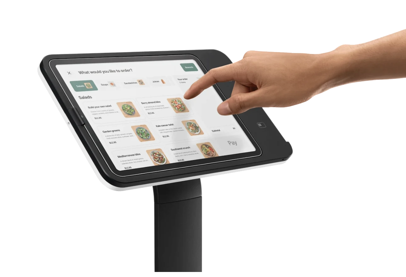 The full INFI ordering platform running on an iPad mounted on a Square Stand, a guest tapping the salad menu